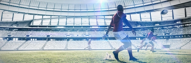 Composite image of rugby player kicking the ball to teammates on field