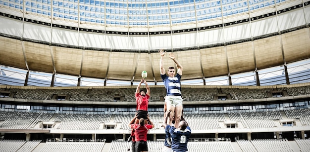 Composite image of rugby players playing match