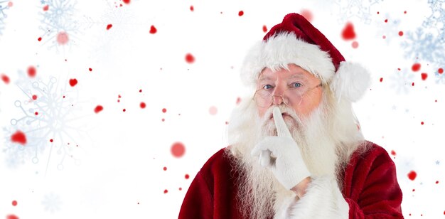 Composite image of santa asking for quiet to camera