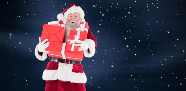 Composite image of santa carries a few presents