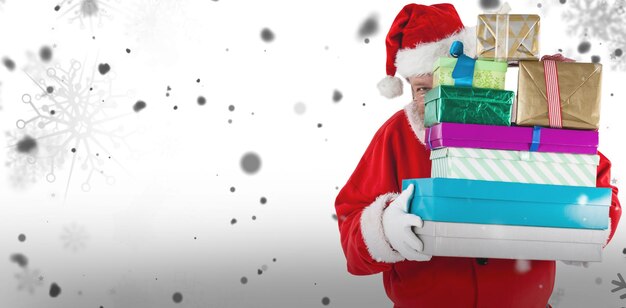 Composite image of santa claus hiding behind christmas presents