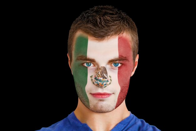 Composite image of serious young mexico fan with facepaint against black