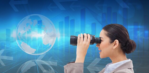 Photo composite image of side view of a businesswoman looking through binoculars