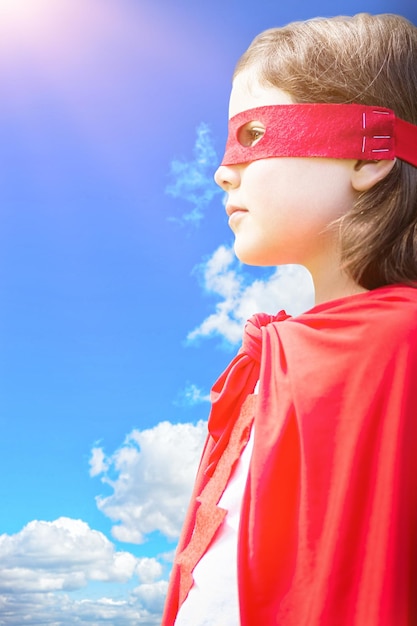 Composite image of side view of girl in red cape