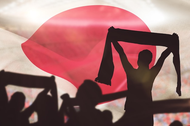 Composite image of silhouettes of football supporters