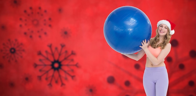 Composite image of smiling blonde woman holding exercise ball