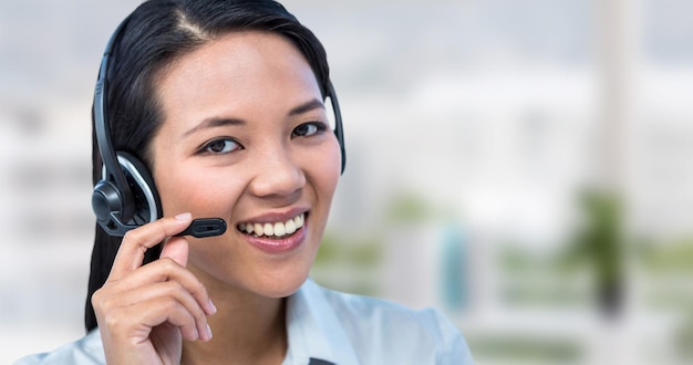 Composite image of smiling businesswoman using headset