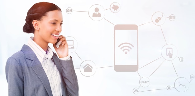 Composite image of smiling businesswoman using mobile phone