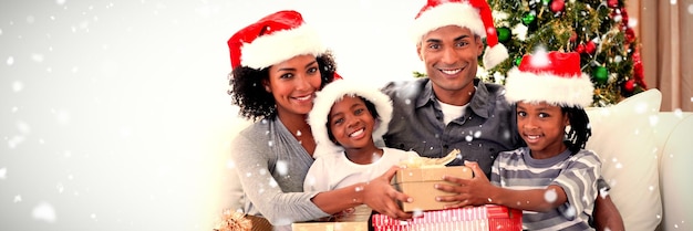 Composite image of smiling family sharing christmas presents