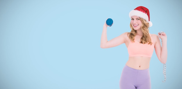 Composite image of smiling fit blonde holding dumbbell and measuring tape