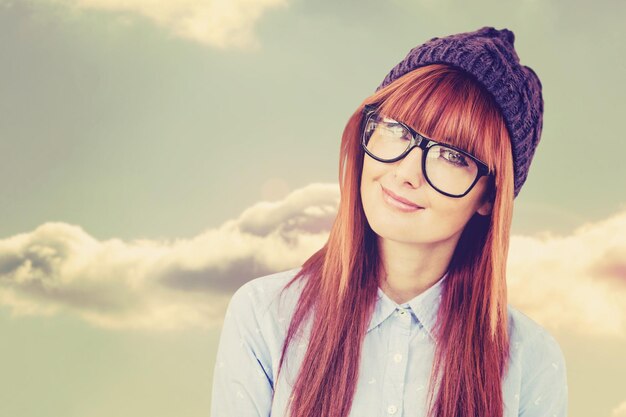 Composite image of smiling hipster woman looking at camera