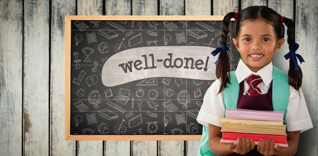 Composite image of smiling schoolgirl carrying books