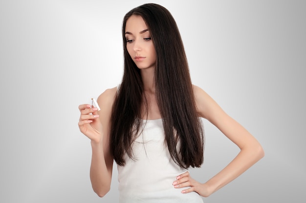 Composite image of smiling woman snapping cigarette in half 