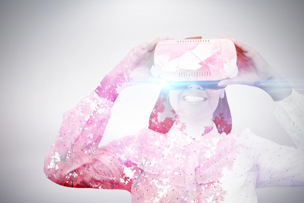 Photo composite image of smiling woman using virtual reality glasses