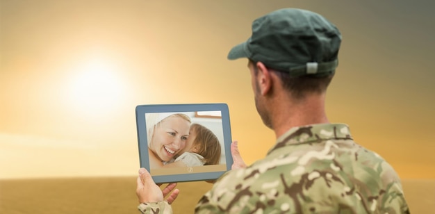 Composite image of soldier using tablet pc