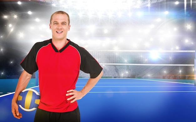 Composite image of sportsman holding a volleyball