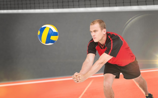 Composite image of sportsman posing while playing volleyball