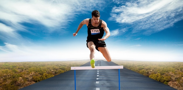 Composite image of sportsman practising hurdles