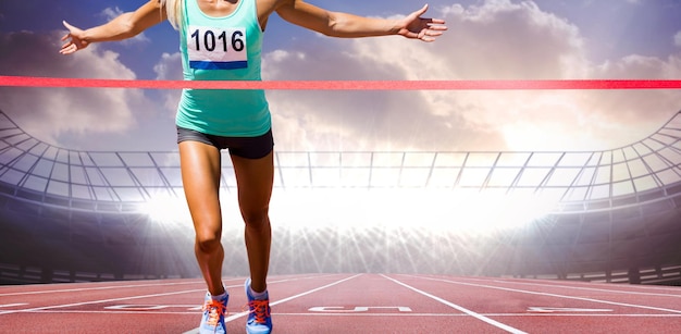 Composite image of sportswoman finishing her run