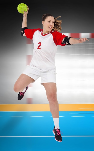 Composite image of sportswoman throwing a ball