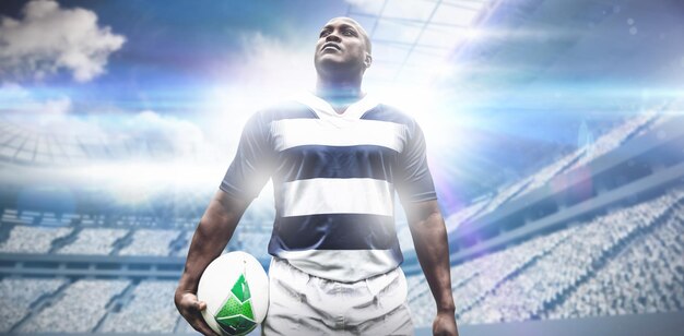 Composite image of strong rugby player