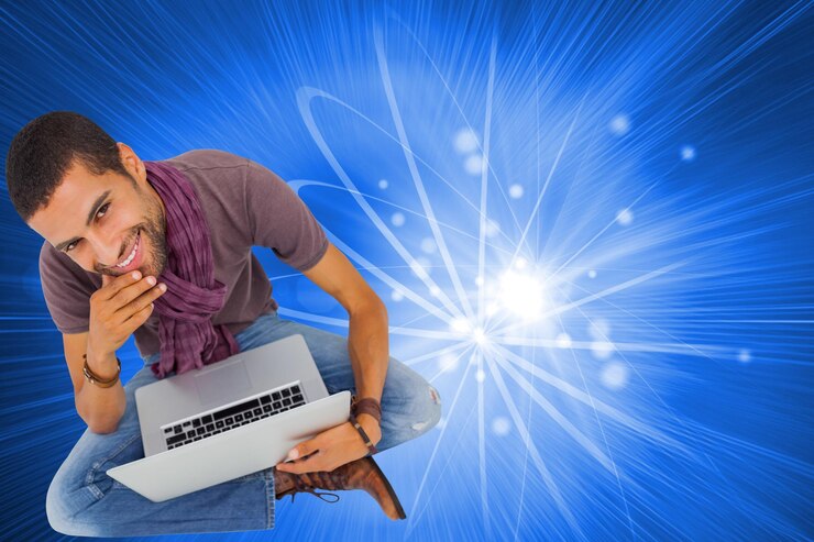 फोटो composite image of thoughtful man sitting on floor using laptop and smiling at camera