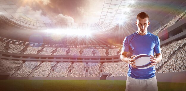 Composite image of thoughtful rugby player holding ball