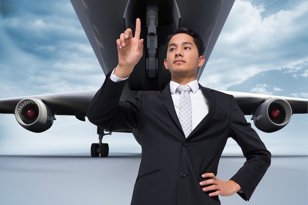 Photo composite image of unsmiling asian businessman pointing