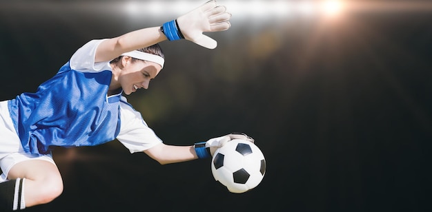 Composite image of woman goalkeeper stopping a goal