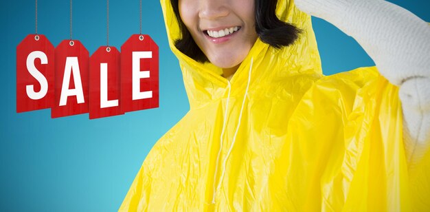 Composite image of woman wearing yellow raincoat against white background