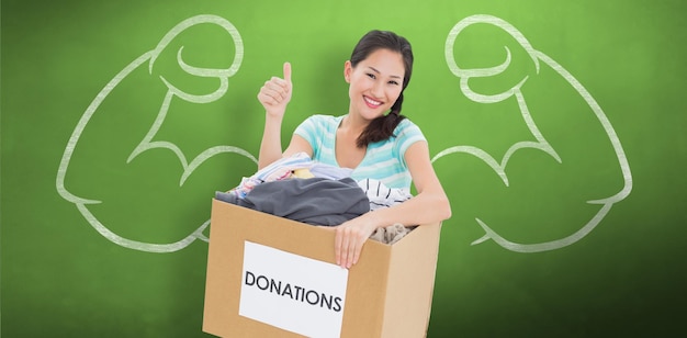 Composite image of woman with clothes donation gesturing thumbs up