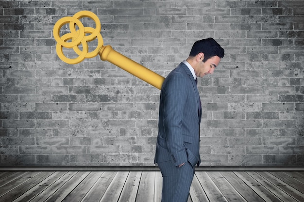 Photo composite image of wound up businessman with hands in pockets against grey room