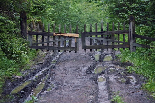 Composite landscape fence near the cross road on hillside meadow in mountains