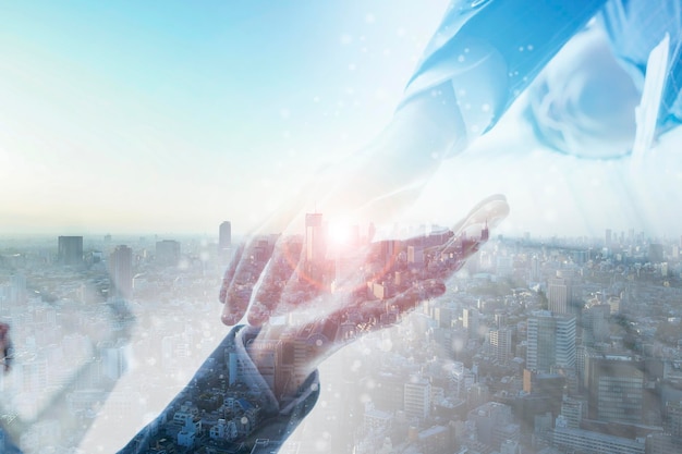 Composite photo of a businessman shaking hands and a city