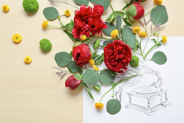 Composition of beautiful flowers and drawn phonograph on paper Creativity concept