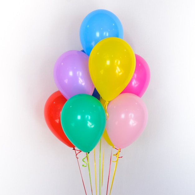 Composition of bright multicolor round balloons on white background Colorful gift for boys and girls