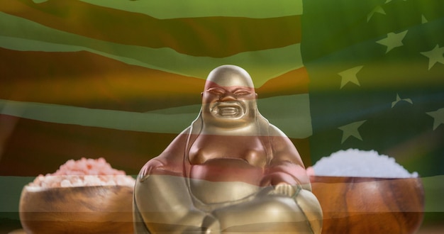 Composition of buddha figure over american flag