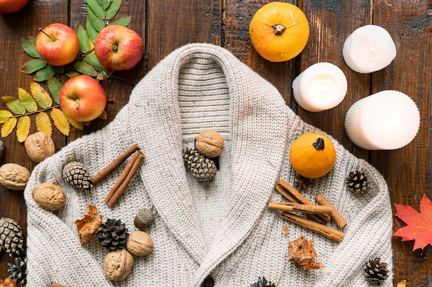 Composition of burning candles, ripe apples and pumpkins