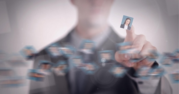 Composition of businesswoman pointing at photo of businesswoman chosen from network