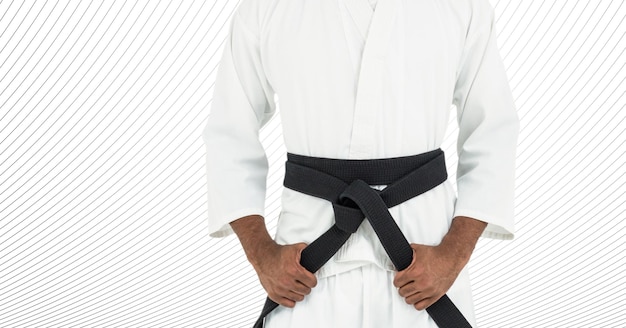 Photo composition of caucasian male martial artist with black belt over stripes on white background