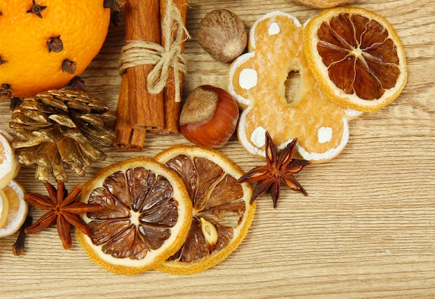 Composition of christmas spices and tangarines, on wooden background