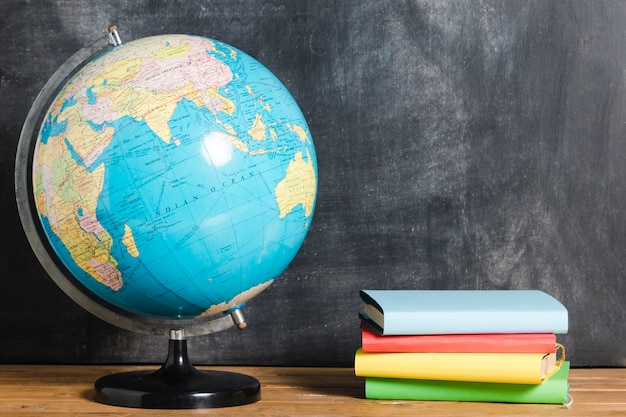 Photo composition of colorful books and globe