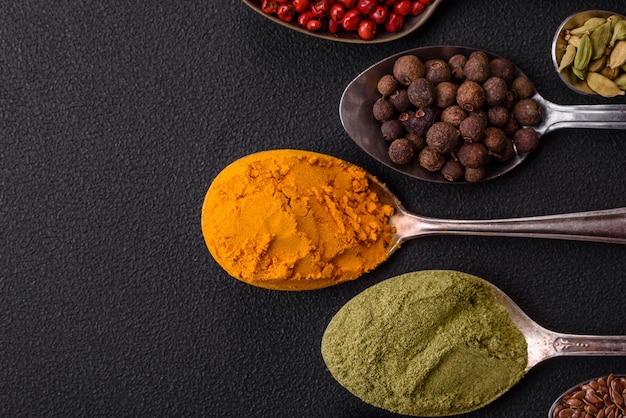 Composition consisting of variations of spices in white bowls and metal spoons