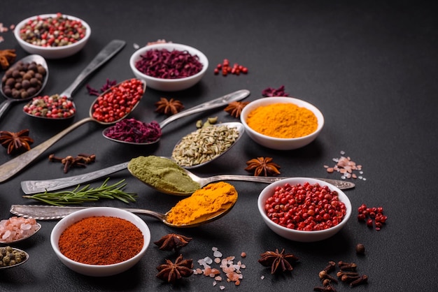 Composition consisting of variations of spices in white bowls and metal spoons