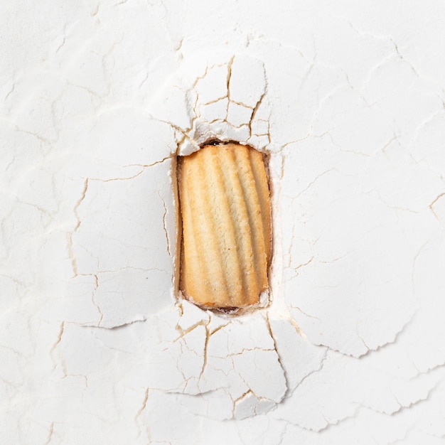 Composition of cookies and flour biscuits in white flour top view