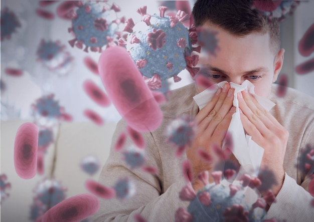 Photo composition of covid 19 cells over sick man blowing his nose. global coronavirus pandemic and health concept digitally generated image.