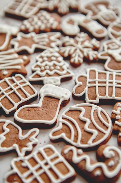 Composition of delicious gingerbread cookies shaped in various Christmas symbols Placed on white rusty table Top view