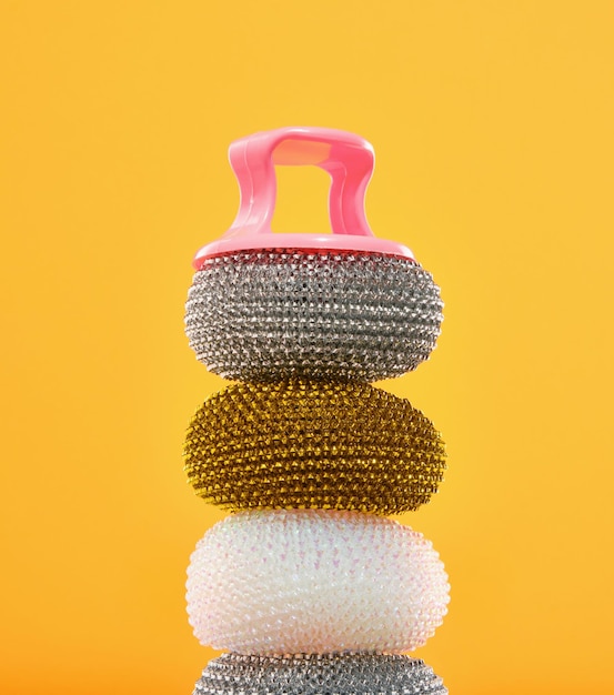 A composition of different abrasive steel sponges for washing dirty dishes lay on top of each other household