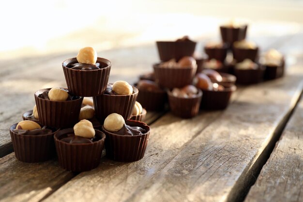 Composition of different chocolate candies on wooden background, close up