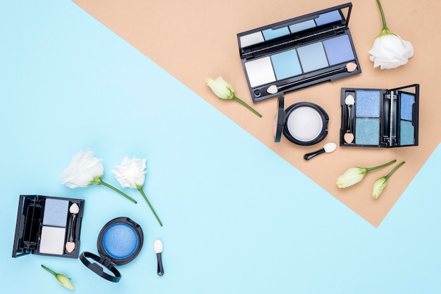 Photo composition of different cosmetics with copy space on bicolor background